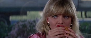 Movie still from “Grease 2” (1982), directed by Patricia Birch – A person eating food; Close Up shot, Over the shoulder angle