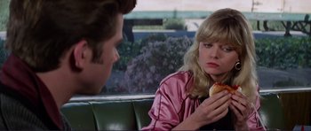 Movie still from “Grease 2” (1982), directed by Patricia Birch – A man and a woman sitting on a bench; Close Up shot, Over the shoulder angle