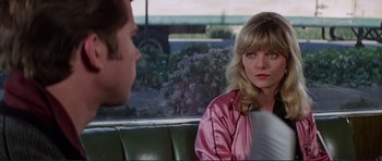 Movie still from “Grease 2” (1982), directed by Patricia Birch – A man and a woman sitting on a bench; Medium shot, Over the shoulder angle