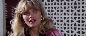 Movie still from “Grease 2” (1982), directed by Patricia Birch – A person with long blonde hair; Close Up shot, Over the shoulder angle