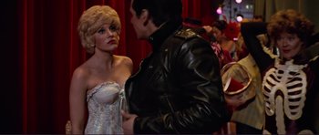 Movie still from “Grease 2” (1982), directed by Patricia Birch – A man and a woman are talking to each other; Medium shot, Over the shoulder angle