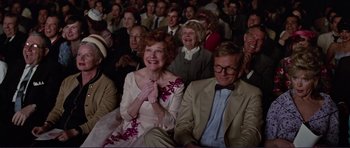 Movie still from “Grease 2” (1982), directed by Patricia Birch – An older woman clapping in front of an older man; Medium shot, Low angle