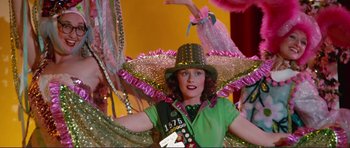 Movie still from “Grease 2” (1982), directed by Patricia Birch – A woman wearing a green shirt and a green hat; Medium shot, Low angle