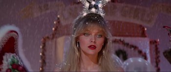 Movie still from “Grease 2” (1982), directed by Patricia Birch – A woman wearing a tiara with a star on top of her head; Close Up shot, Low angle