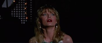 Movie still from “Grease 2” (1982), directed by Patricia Birch – A woman with long blonde hair wearing a white dress; Close Up shot, Low angle