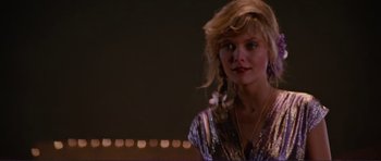 Movie still from “Grease 2” (1982), directed by Patricia Birch – A woman with long blonde hair wearing a purple dress; Close Up shot, Low angle