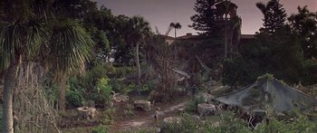 Movie still from “Great Expectations” (1998), directed by Alfonso Cuarón – People walking in a lush green garden at night; Extreme Wide shot, High angle