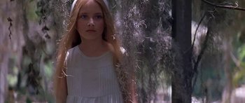 Movie still from “Great Expectations” (1998), directed by Alfonso Cuarón – A girl in a white dress standing next to a tree; Close Up shot, Low angle
