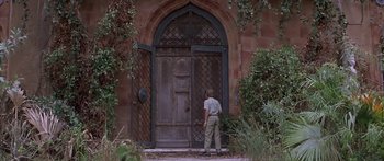 Movie still from “Great Expectations” (1998), directed by Alfonso Cuarón – A man standing in front of an open door; Wide shot, Low angle
