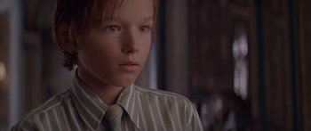 Movie still from “Great Expectations” (1998), directed by Alfonso Cuarón – A young boy wearing a striped shirt and a tie; Close Up shot, Low angle