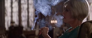Movie still from “Great Expectations” (1998), directed by Alfonso Cuarón – A woman holding a cigarette in her hand with smoke coming out of it; Close Up shot, Low angle
