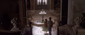 Movie still from “Great Expectations” (1998), directed by Alfonso Cuarón – Two children are walking through a courtyard with a fountain in the background; Wide shot, High angle