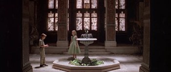 Movie still from “Great Expectations” (1998), directed by Alfonso Cuarón – A little girl standing in front of a water fountain; Wide shot, Low angle