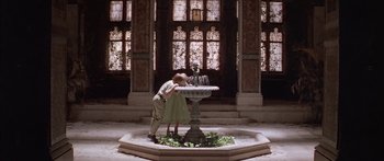 Movie still from “Great Expectations” (1998), directed by Alfonso Cuarón – A man and a woman kissing in front of a fountain; Wide shot, High angle