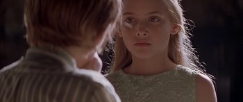 Movie still from “Great Expectations” (1998), directed by Alfonso Cuarón – A young girl looking into a mirror while standing next to another girl; Close Up shot, Over the shoulder angle