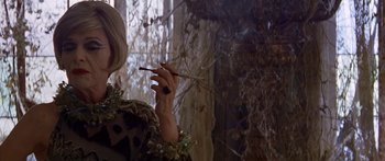 Movie still from “Great Expectations” (1998), directed by Alfonso Cuarón – A woman holding a cigarette in her hand; Close Up shot, Over the shoulder angle