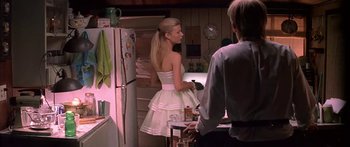 Movie still from “Great Expectations” (1998), directed by Alfonso Cuarón – A woman in a white dress standing next to a man; Medium shot, Over the shoulder angle