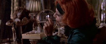 Movie still from “Great Expectations” (1998), directed by Alfonso Cuarón – An older woman is putting lipstick on in front of a mirror; Close Up shot, Over the shoulder angle