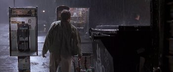 Movie still from “Great Expectations” (1998), directed by Alfonso Cuarón – A person walking in the rain with a shopping cart; Wide shot, Low angle