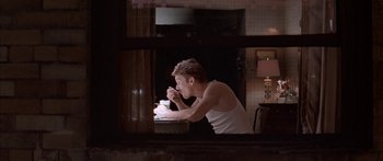 Movie still from “Great Expectations” (1998), directed by Alfonso Cuarón – A man sitting in front of a cake in front of a fireplace; Medium shot, High angle