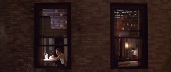 Movie still from “Great Expectations” (1998), directed by Alfonso Cuarón – A woman sitting at a table in front of a brick wall; Wide shot, High angle