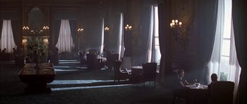 Movie still from “Great Expectations” (1998), directed by Alfonso Cuarón – People sitting in chairs in a large room with windows; Extreme Wide shot, High angle