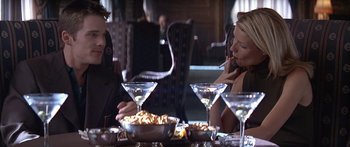 Movie still from “Great Expectations” (1998), directed by Alfonso Cuarón – A man and a woman sitting at a dinner table; Medium shot, Low angle