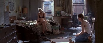 Movie still from “Great Expectations” (1998), directed by Alfonso Cuarón – A woman sitting on top of a bed next to a window; Wide shot, High angle