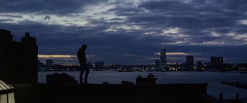 Movie still from “Great Expectations” (1998), directed by Alfonso Cuarón – A man standing next to a body of water at night; Extreme Wide shot, Low angle