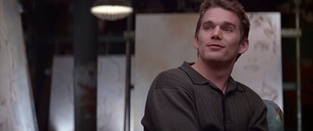 Movie still from “Great Expectations” (1998), directed by Alfonso Cuarón – A man that is standing in a room; Close Up shot, Over the shoulder angle