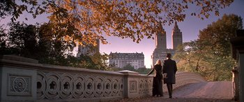 Movie still from “Great Expectations” (1998), directed by Alfonso Cuarón – Two people are walking on a bridge in the fall; Wide shot, Low angle