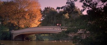 Movie still from “Great Expectations” (1998), directed by Alfonso Cuarón – Two people sitting on a bridge over a river; Extreme Wide shot, High angle