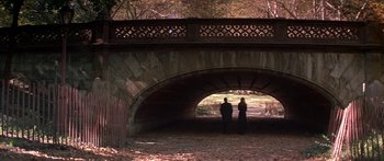 Movie still from “Great Expectations” (1998), directed by Alfonso Cuarón – Two people standing under a bridge in the woods; Wide shot, High angle