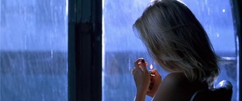 Movie still from “Great Expectations” (1998), directed by Alfonso Cuarón – A woman holding a cigarette in her hand; Close Up shot, Over the shoulder angle