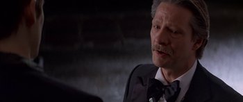 Movie still from “Great Expectations” (1998), directed by Alfonso Cuarón – An older man wearing a suit and bow tie; Close Up shot, Over the shoulder angle