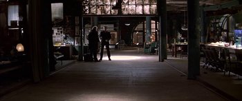 Movie still from “Great Expectations” (1998), directed by Alfonso Cuarón – Two people are standing in a building with a light shining on them; Wide shot, High angle