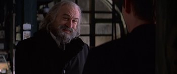 Movie still from “Great Expectations” (1998), directed by Alfonso Cuarón – An old man with a beard and a suit and tie; Close Up shot, Over the shoulder angle