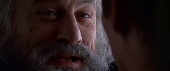 Movie still from “Great Expectations” (1998), directed by Alfonso Cuarón – An old man with long grey hair and a long beard; Extreme Close Up shot, Over the shoulder angle