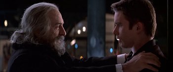 Movie still from “Great Expectations” (1998), directed by Alfonso Cuarón – A man and a man with a beard talking to each other; Close Up shot, Over the shoulder angle