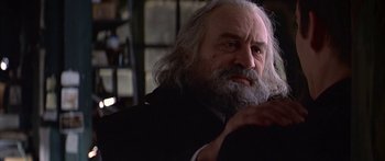 Movie still from “Great Expectations” (1998), directed by Alfonso Cuarón – An old man with a beard and a white beard; Close Up shot, Over the shoulder angle