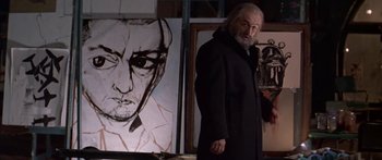Movie still from “Great Expectations” (1998), directed by Alfonso Cuarón – A man standing in front of a painting of a man; Close Up shot, Low angle