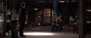 Movie still from “Great Expectations” (1998), directed by Alfonso Cuarón – A man in a suit sitting on a chair in an empty room; Wide shot, High angle