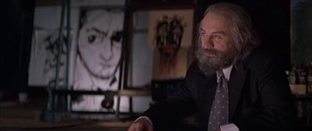 Movie still from “Great Expectations” (1998), directed by Alfonso Cuarón – An older man sitting in front of a painting; Medium shot, Low angle