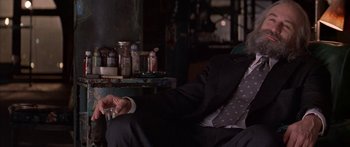 Movie still from “Great Expectations” (1998), directed by Alfonso Cuarón – A man in a suit sitting in a room; Close Up shot, High angle