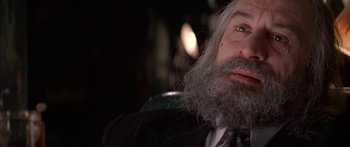 Movie still from “Great Expectations” (1998), directed by Alfonso Cuarón – An old man with a long gray beard; Close Up shot, Over the shoulder angle