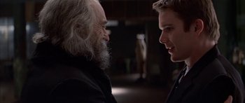 Movie still from “Great Expectations” (1998), directed by Alfonso Cuarón – Two men talking to each other in a dark room; Close Up shot, Over the shoulder angle