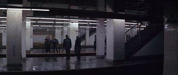 Movie still from “Great Expectations” (1998), directed by Alfonso Cuarón – Two men are standing in a train station; Extreme Wide shot, High angle