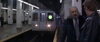 Movie still from “Great Expectations” (1998), directed by Alfonso Cuarón – A woman is standing in front of a subway train; Medium shot, Low angle