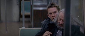 Movie still from “Great Expectations” (1998), directed by Alfonso Cuarón – A man with a beard is holding a cell phone; Medium shot, Over the shoulder angle