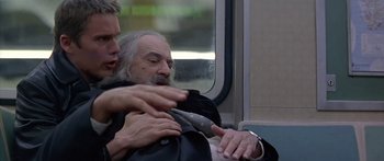 Movie still from “Great Expectations” (1998), directed by Alfonso Cuarón – A man with a beard is getting his hair cut on a train; Medium shot, Low angle